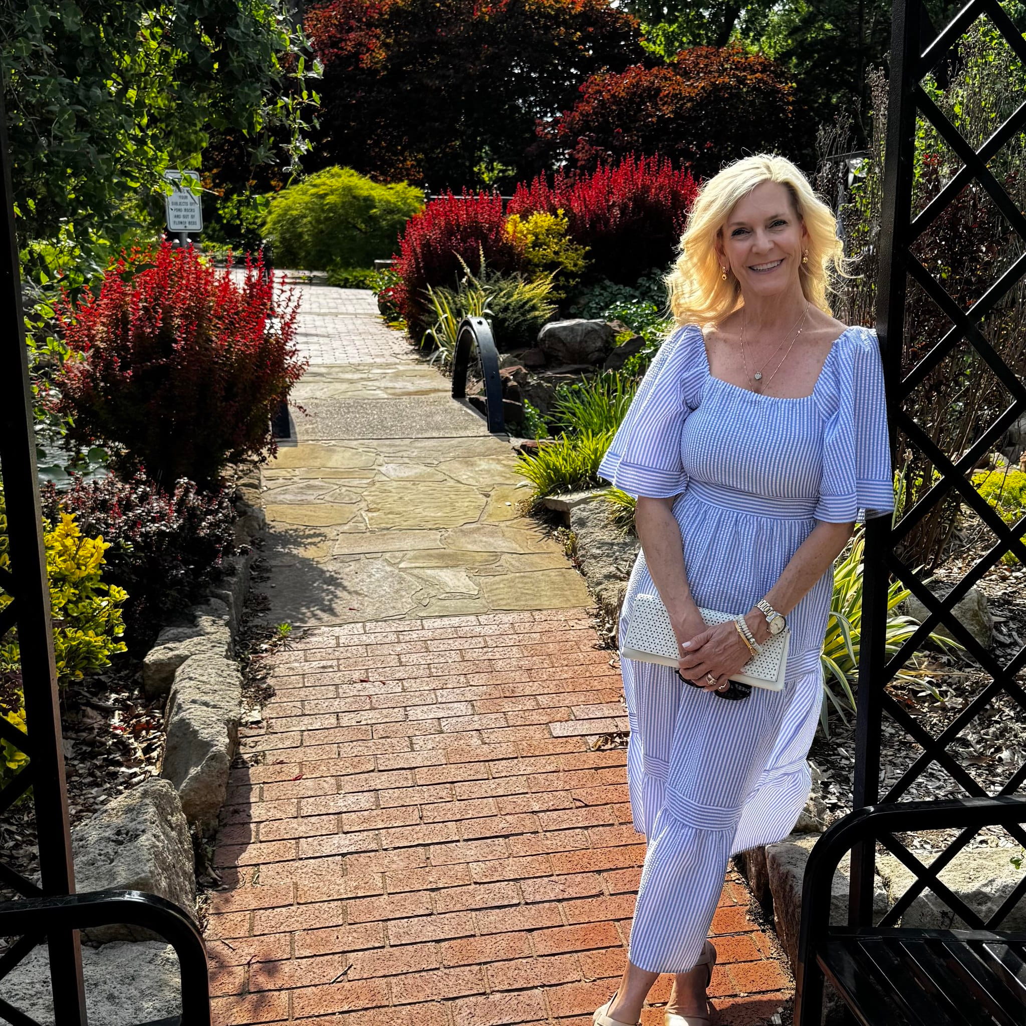 Dana Iman standing in a garden walkway